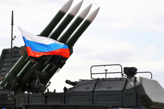 Military launcher with four missiles and Russian flag