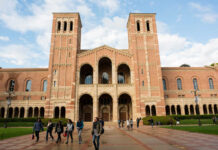 People walking outside a historic brick university building