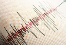 Seismograph displaying earthquake activity on graph paper