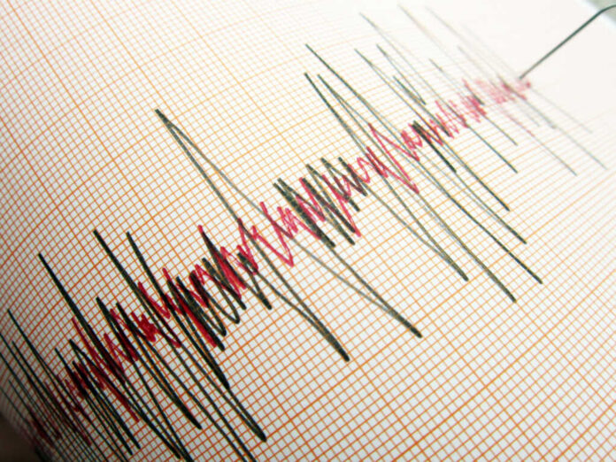 Seismograph displaying earthquake activity on graph paper