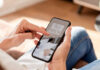 Person using a smartphone to access telehealth services