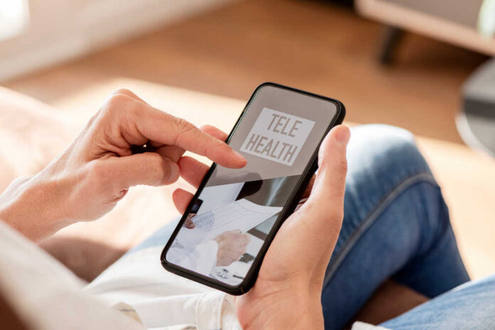 Person using a smartphone to access telehealth services