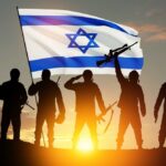 Silhouetted soldiers saluting while holding a flag