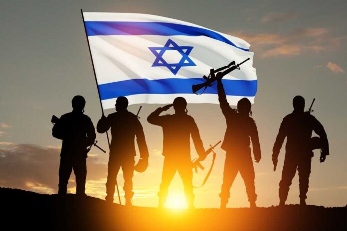 Silhouetted soldiers saluting while holding a flag