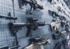 A wall displaying various firearms in a gun shop