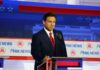 A political candidate standing at a podium during a debate
