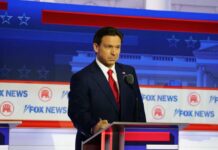 A political candidate standing at a podium during a debate