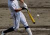 A baseball player swinging a bat at a pitch