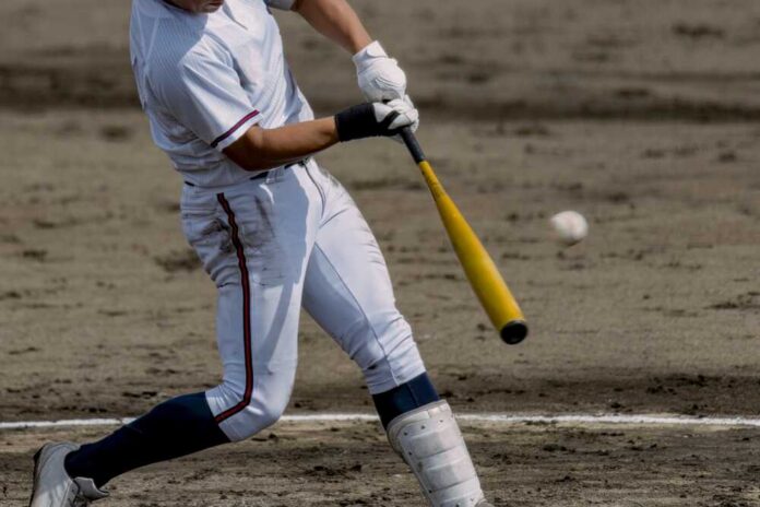 A baseball player swinging a bat at a pitch