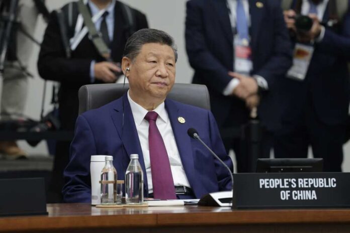 A leader seated at a conference table during an international summit