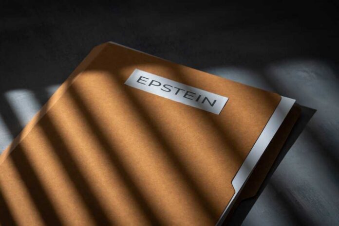 A brown file folder with the name 'EPSTEIN' on it, partially illuminated by light and casting shadows.