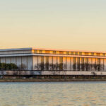 Sign for the John F. Kennedy Center for the Performing Arts with trees in the background
