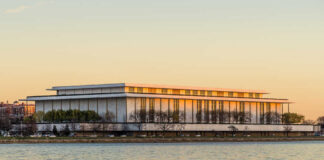 Sign for the John F. Kennedy Center for the Performing Arts with trees in the background