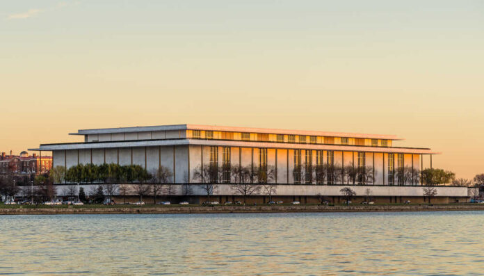 Sign for the John F. Kennedy Center for the Performing Arts with trees in the background