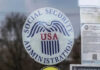 Social Security Administration USA logo on glass door.