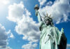 Statue of Liberty under a cloudy sky.