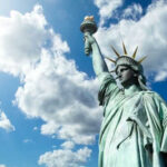 Statue of Liberty under a cloudy sky.