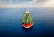 Oil tanker sailing straight through calm open sea
