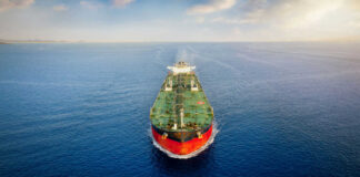 Oil tanker sailing straight through calm open sea