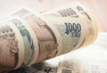 Stack of rolled Japanese yen banknotes.