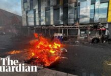 Bus and cars burned in anti-immigration protests in Belfast after stabbing