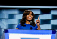 I dont know who this is speaking at a podium