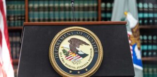 Podium with the Department of Justice seal and American flag in the background