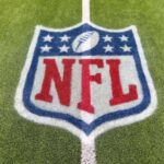 NFL logo painted on a football field