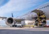 Airplane being loaded with cargo at the ramp