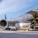 Airplane being loaded with cargo at the ramp