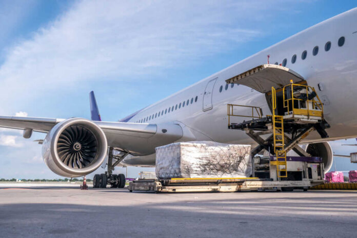 Airplane being loaded with cargo at the ramp