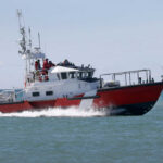 Red and white coast guard boat on ocean water
