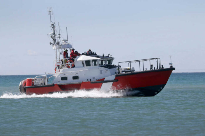 Red and white coast guard boat on ocean water