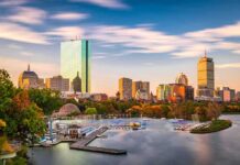 City skyline with river and boats at sunset