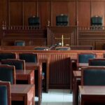 Empty courtroom with wooden benches and judge's bench