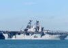 Aircraft carrier sailing on calm blue water