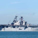 Aircraft carrier sailing on calm blue water