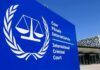 International Criminal Court sign with scales emblem outside modern building