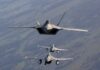 Three military fighter jets flying in formation in the sky