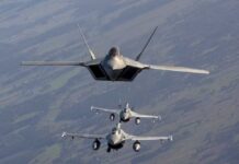 Three military fighter jets flying in formation in the sky