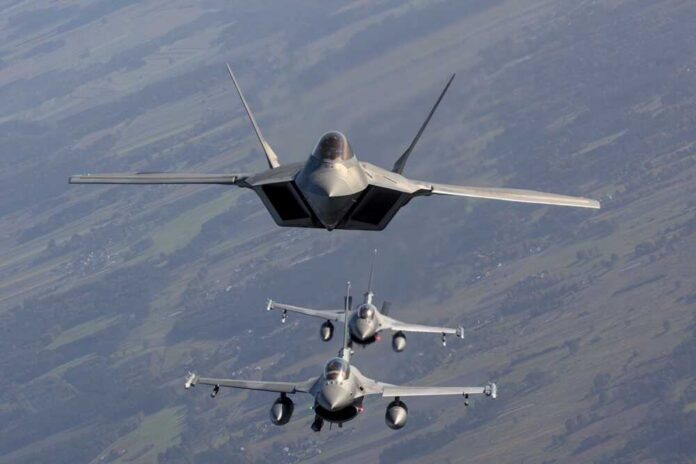 Three military fighter jets flying in formation in the sky