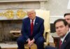 A serious-looking man in a suit sitting in a presidential office during a meeting