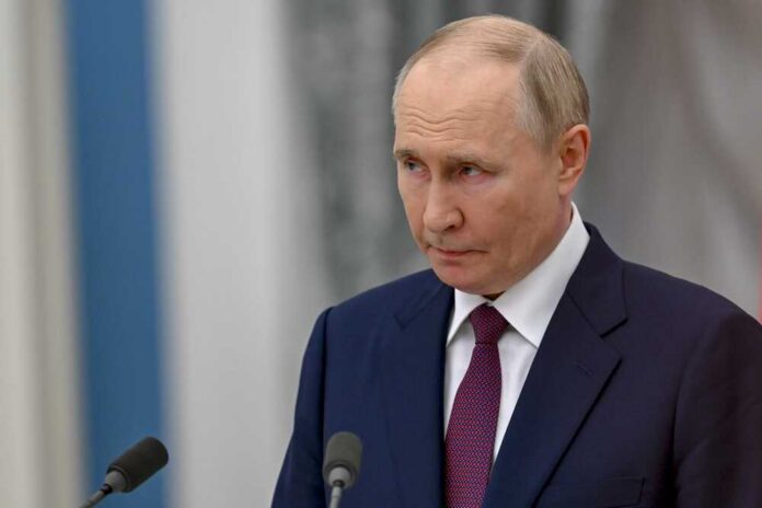 A serious-looking man in a suit during a press conference