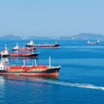 Several cargo ships navigating in a calm ocean