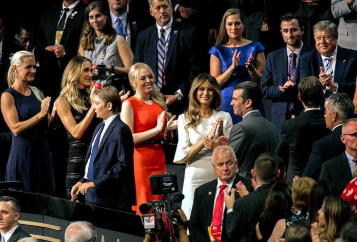Audience members applauding at a formal indoor event