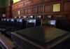Empty wooden jury box with numbered chairs
