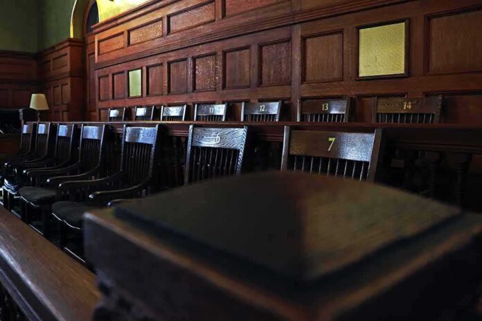 shutterstock_1132288550 Empty wooden jury box with numbered chairs