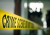 crime scene tape in a blurred indoor setting