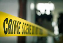 crime scene tape in a blurred indoor setting
