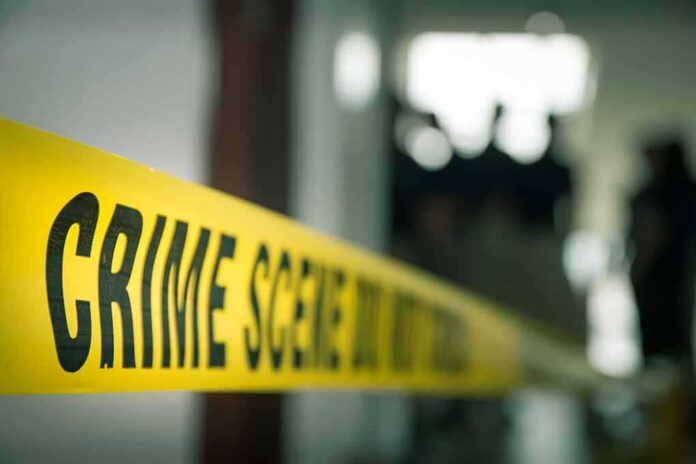 crime scene tape in a blurred indoor setting
